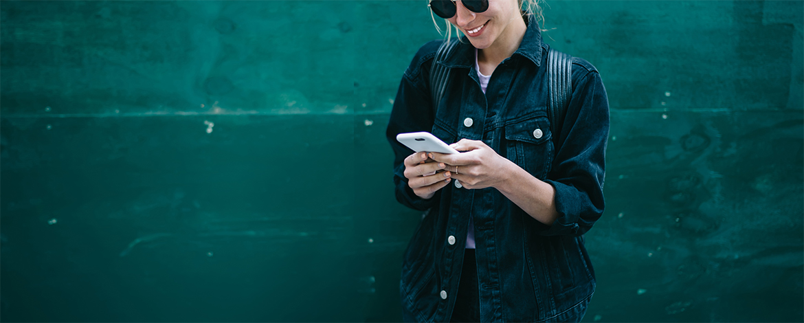 Person on a bicycle holding a cell phone.